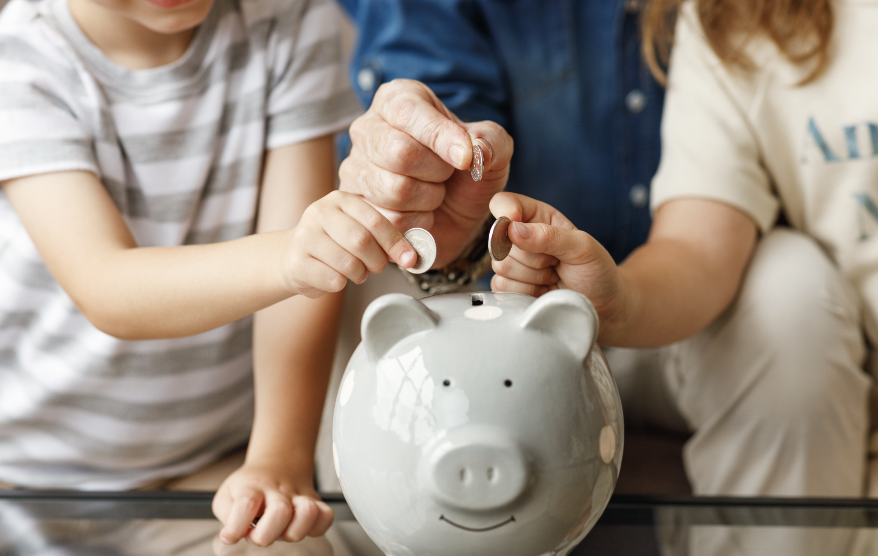 grandfather and grandchildren saving money