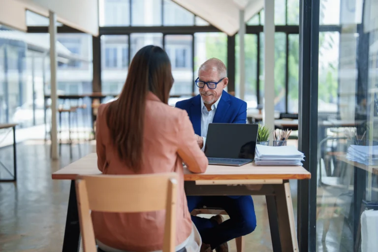 Executive discussing 401(k) and retirement planning in a modern office